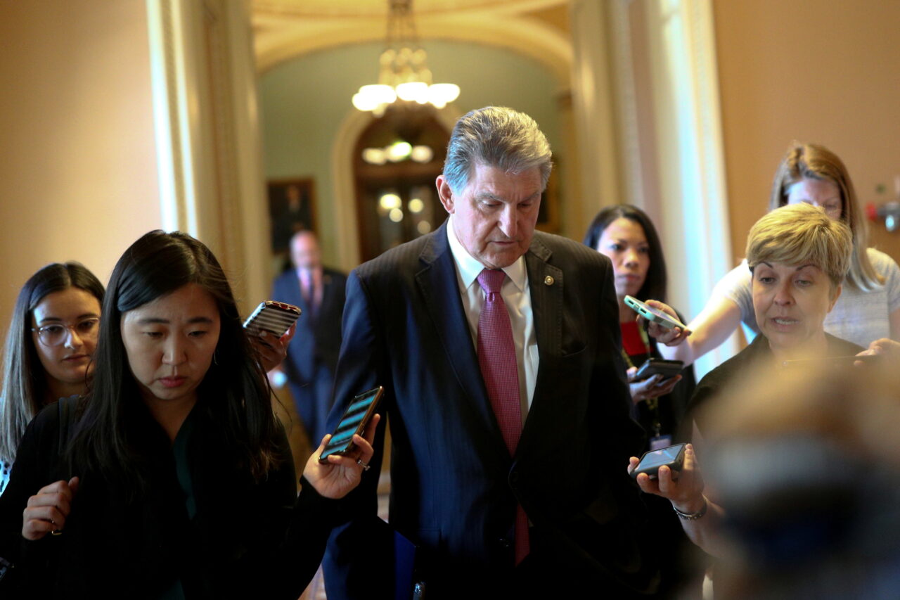 FILE PHOTO: Senator Manchin speaks to news reporters before attending a meeting on infrastructure on Capitol Hill in Washington