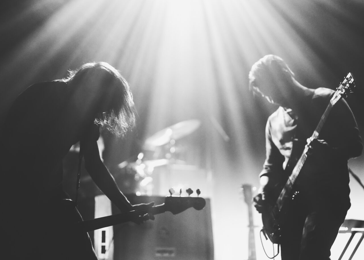 Rock band on a stage in a backlights