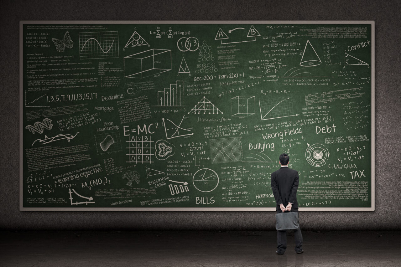 Businessman looking at hand drawn chalkboard