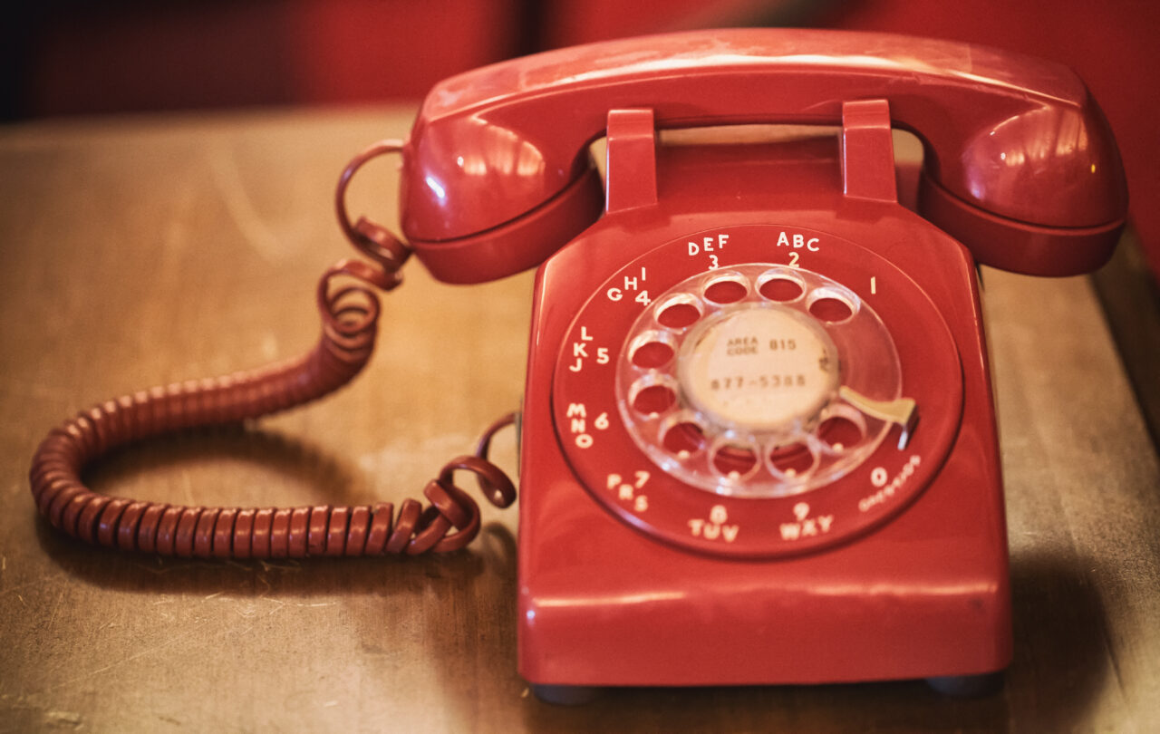 Old red phone on table