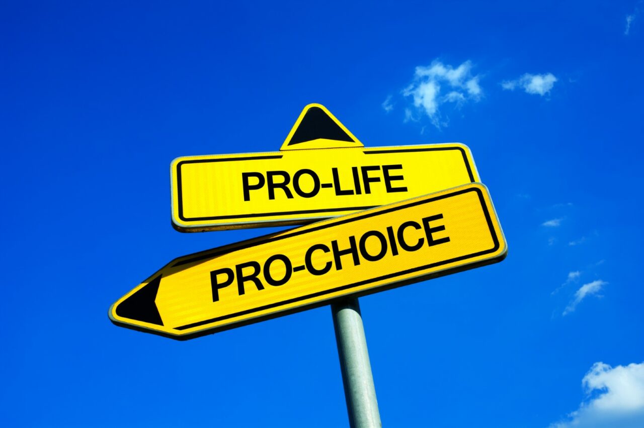 Pro-life vs Pro-choice - Traffic sign with two options - ethical