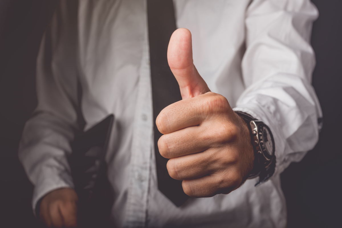 Businessman gesturing thumbs up sign