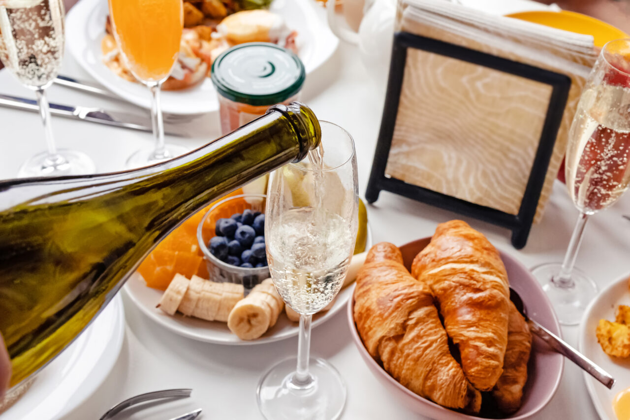 Pouring champagne to the glass close-up.