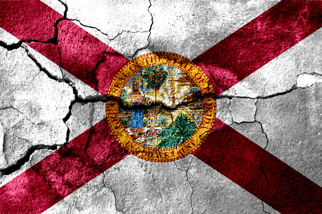 Florida rusted cracked flag, rusty background. United States of