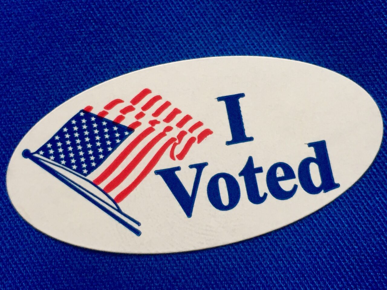 "I voted" sticker on blue fabric