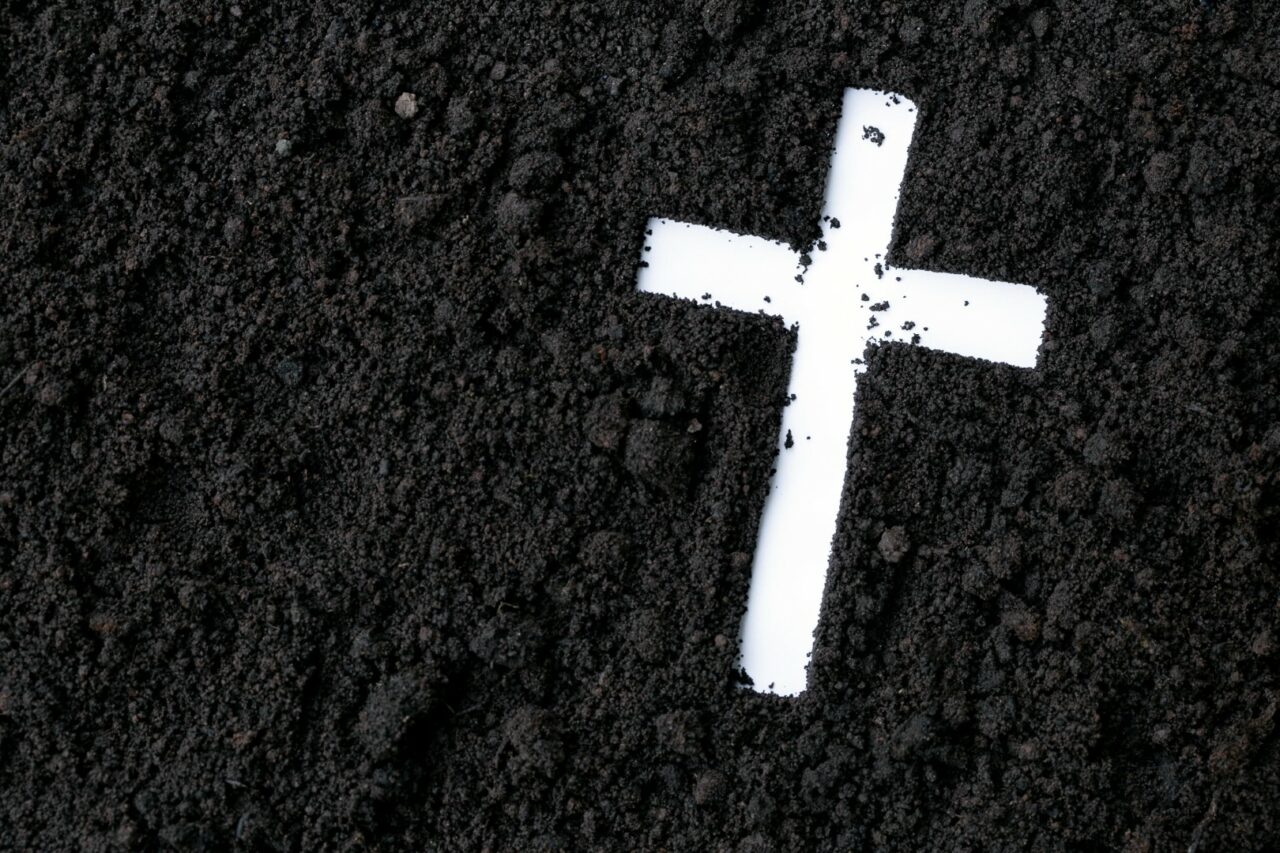 Cross or crucifix made of ash, dust or sand. Ash Wednesday. Lent