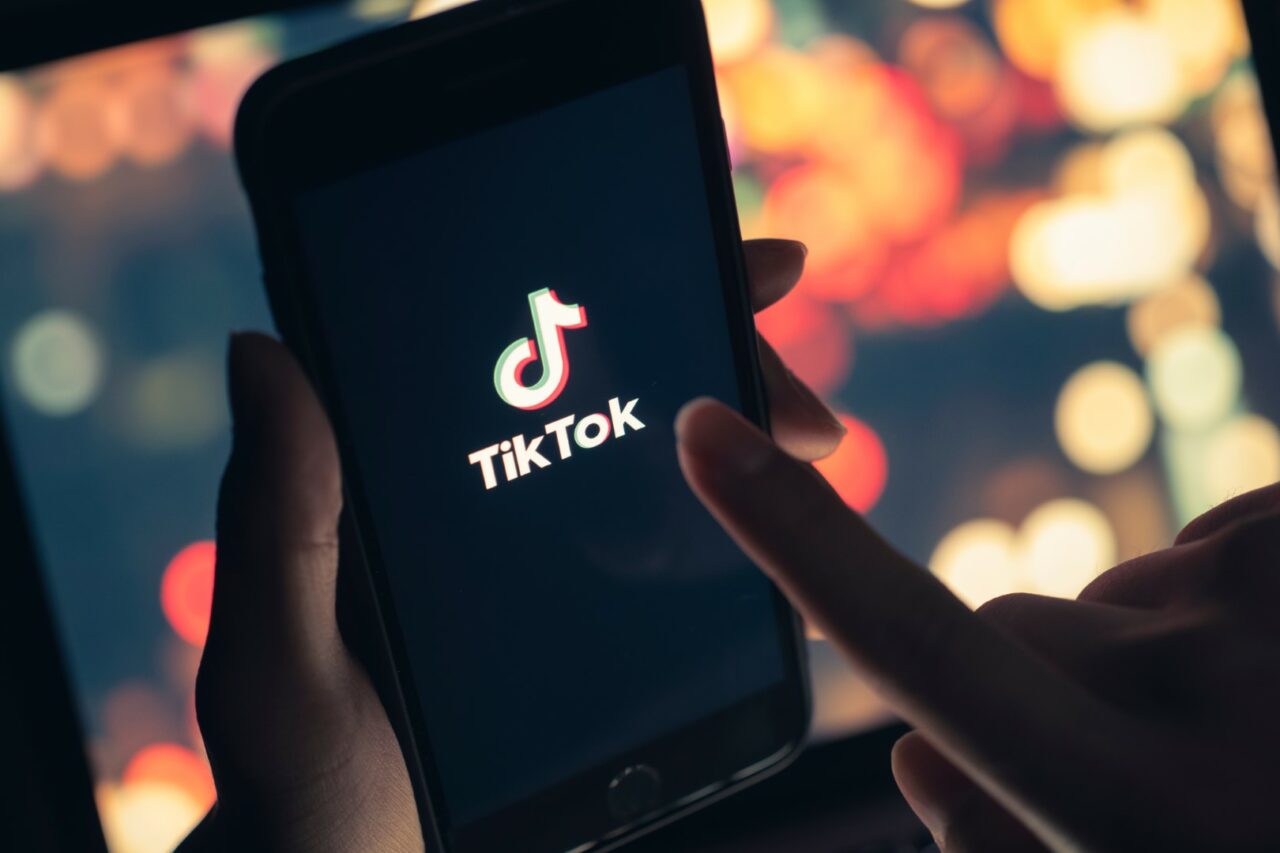 Tik Tok application icon on iPhone 11 pro max screen in hand and