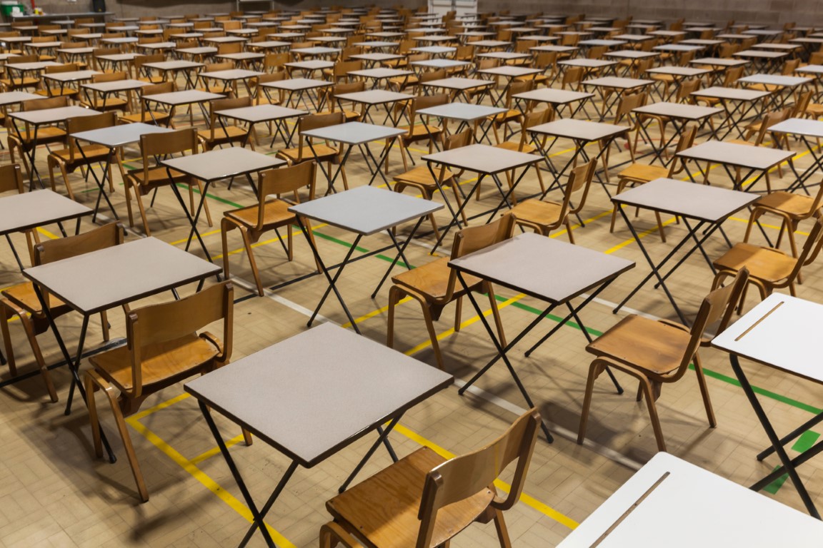 Exam tables set up in a sports hall for exams in a high school &