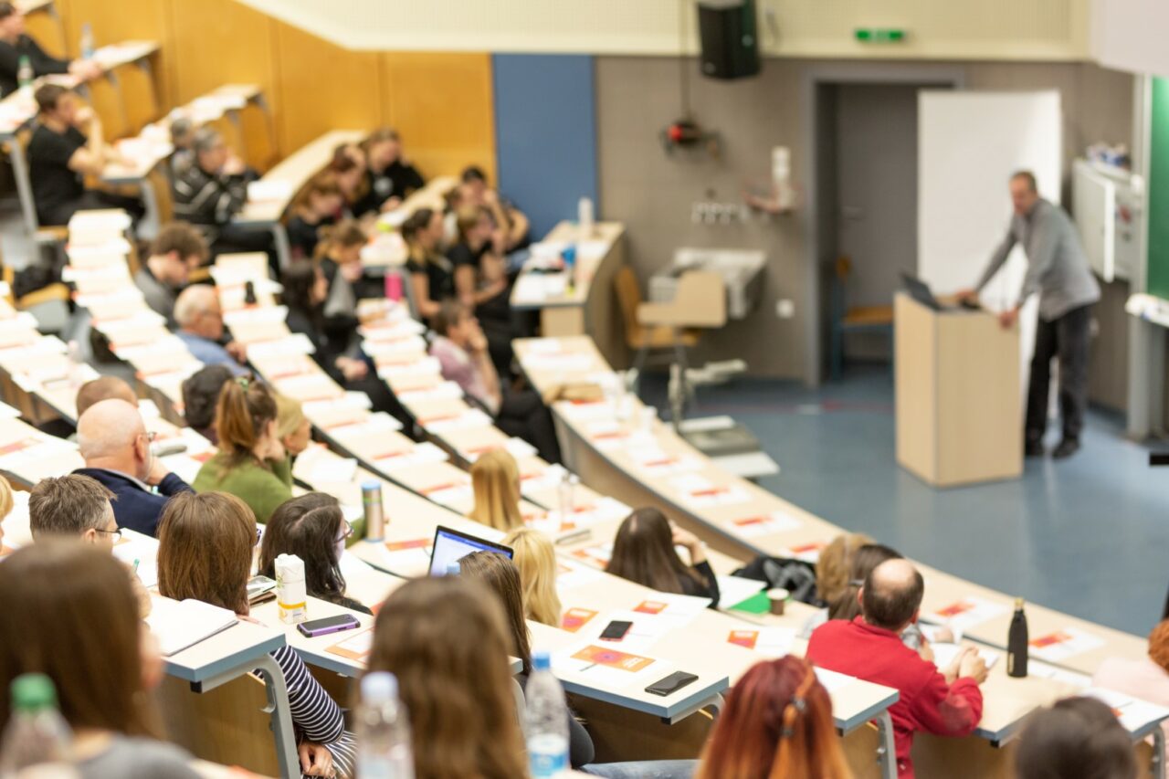 Expert speaker giving a talk at scientific business conference event.