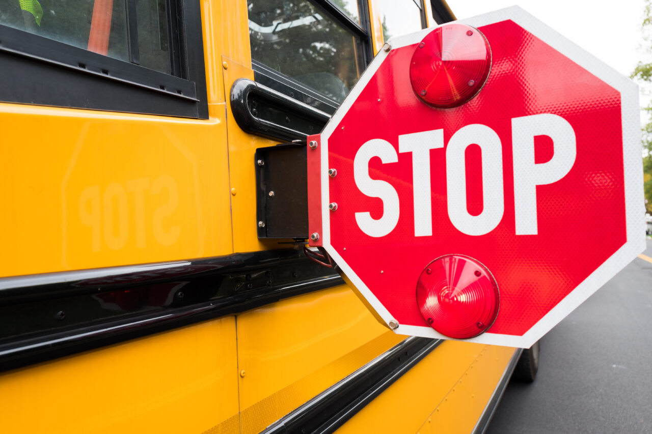 school bus stop sign on side of bus