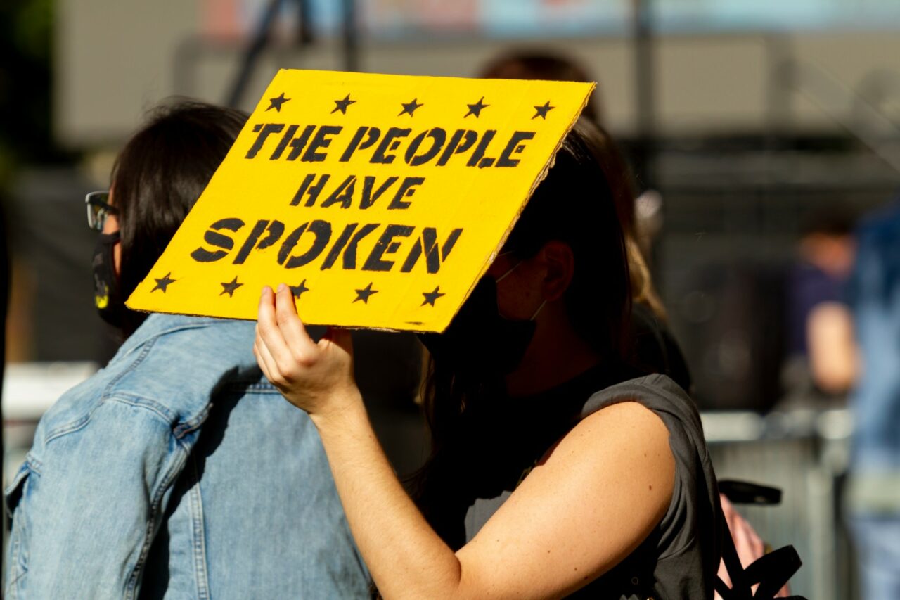 A young caucasian woman in a demonstration after US election is