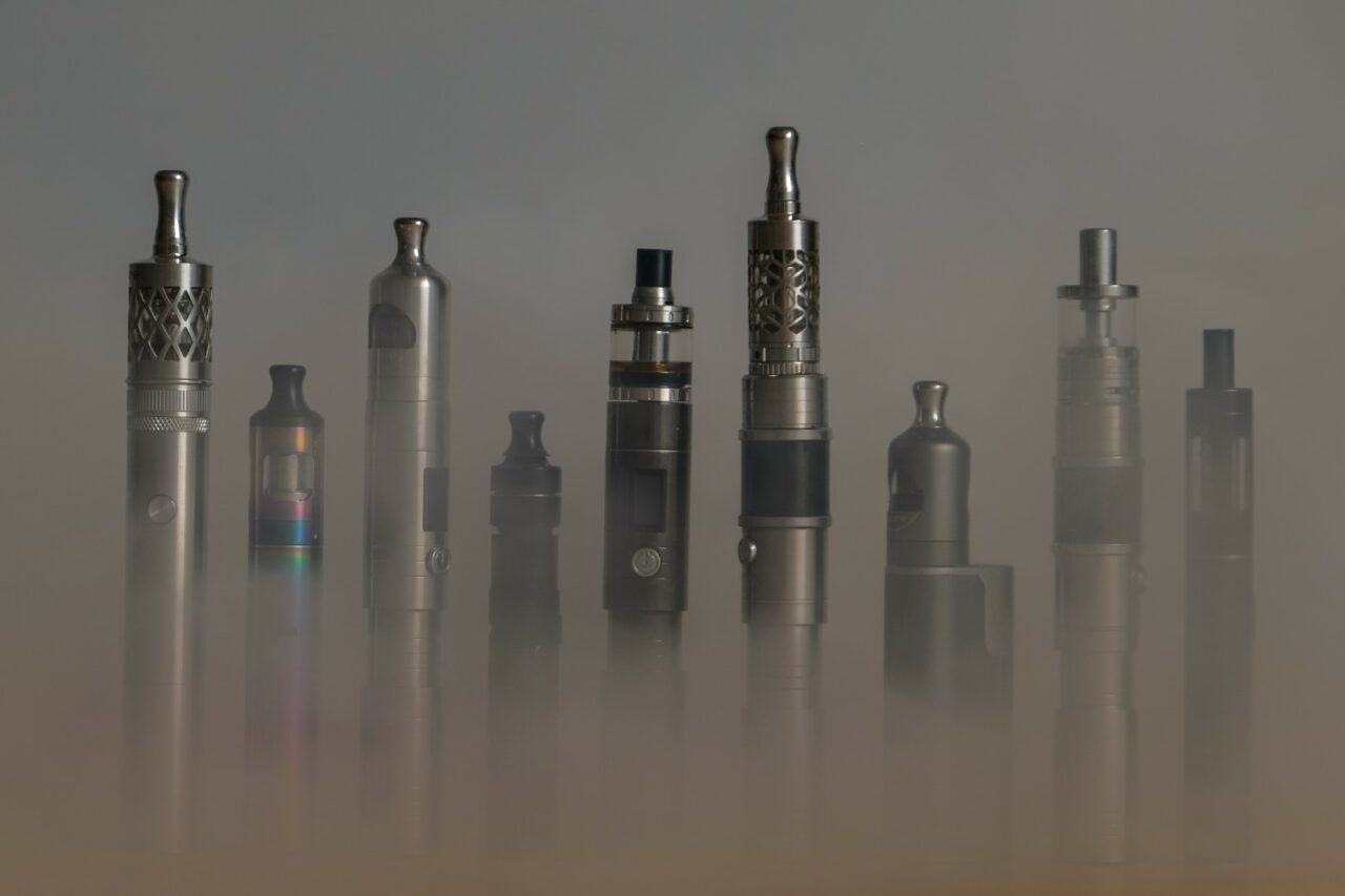 Collection of e-cigarettes or electronic cigarettes for liquid and vaping are displayed on clean backhground