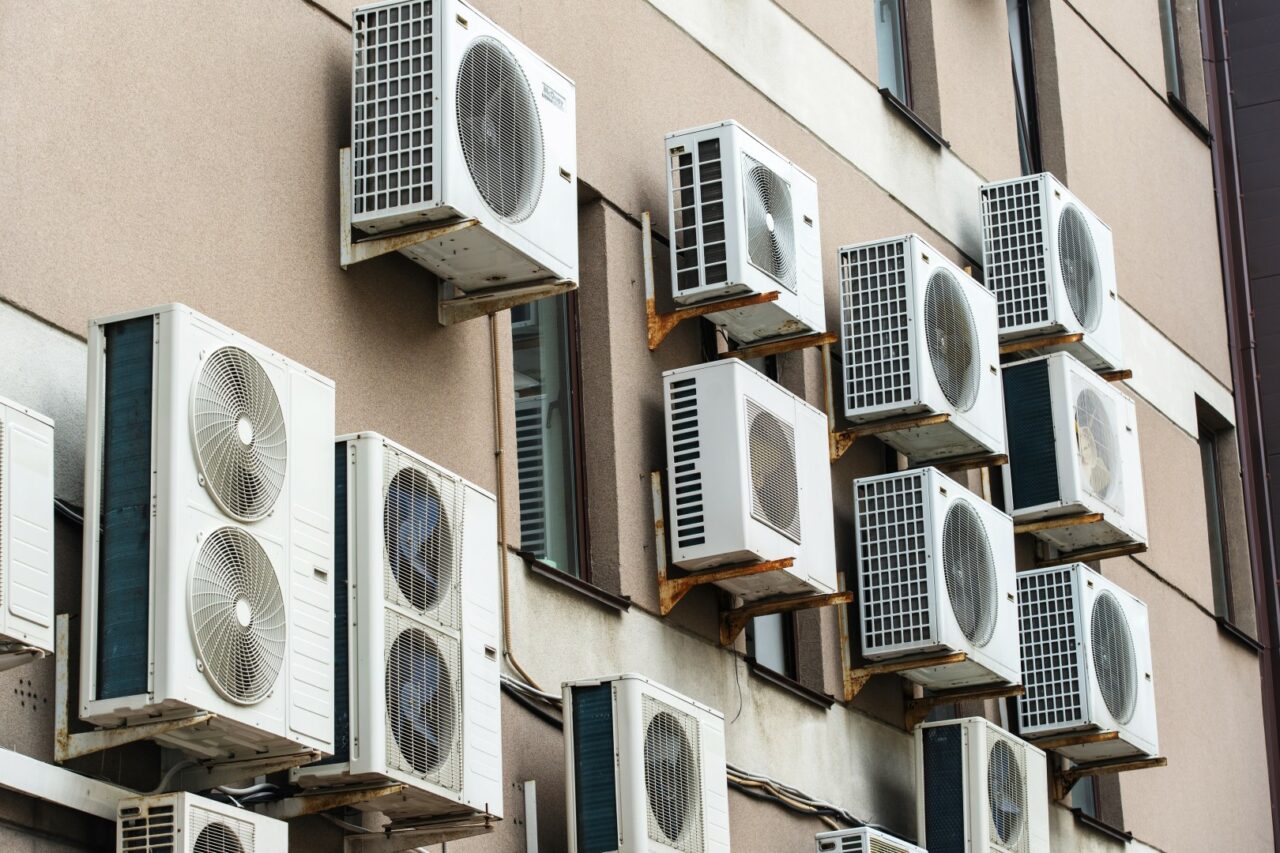 Air conditioning equipment hangs on the facade of the building. Close-up