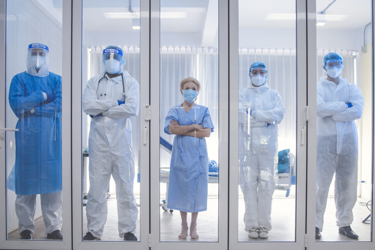 Dortor, Nurse and patient looking out in the quarantine room from case of coronavirus covid 19. Virus infected patient with outbreak at hospital with coronavirus covid 19 disease treatment.