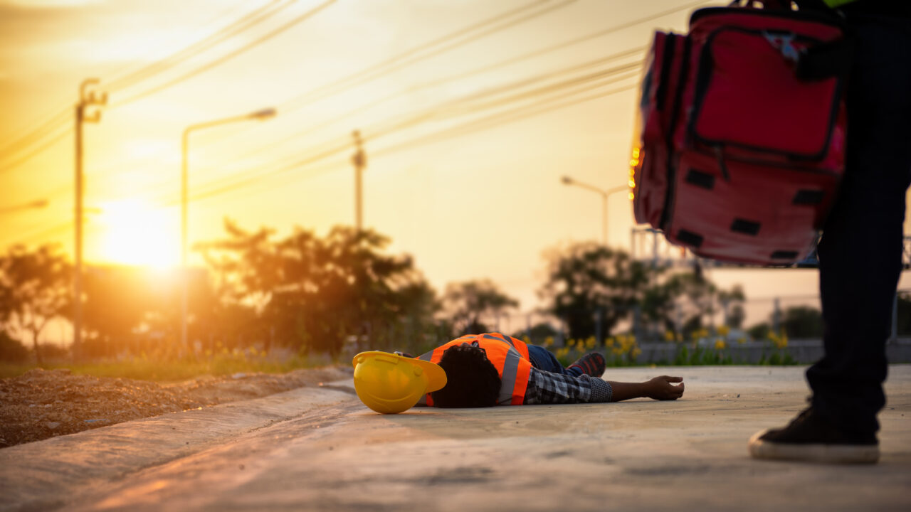 Accident at work of construction labor people, Basic First aid and CPR Training at outdoor. Heat Stroke or Heat exhaustion in body concept.