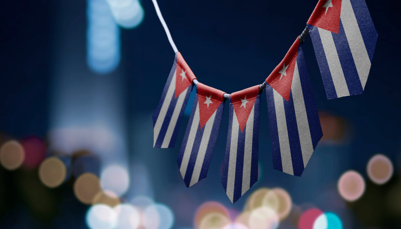 A garland of Cuba national flags on an abstract blurred background