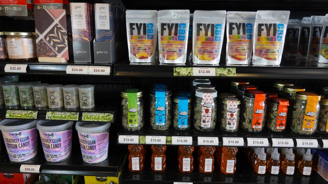Various CBD infused edible products on a shelf inside retail store. Photo taken in Vista, CA / USA - November 25, 2019.
