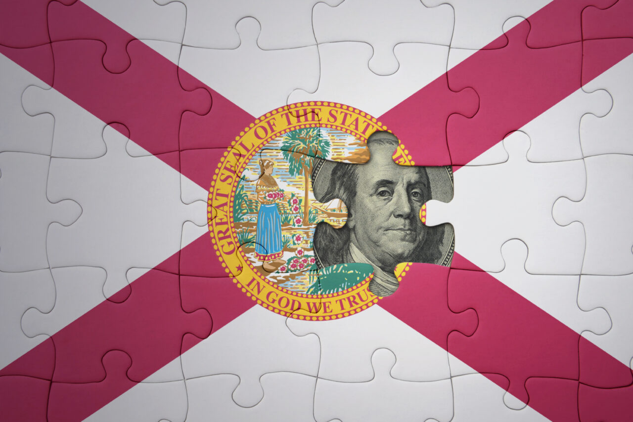 puzzle with the national flag of florida state and usa dollar banknote. finance concept