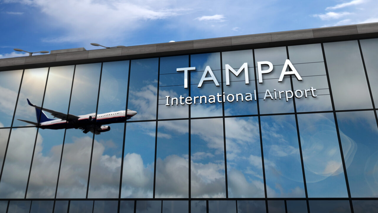 Airplane landing at Tampa Florida, USA airport mirrored in terminal