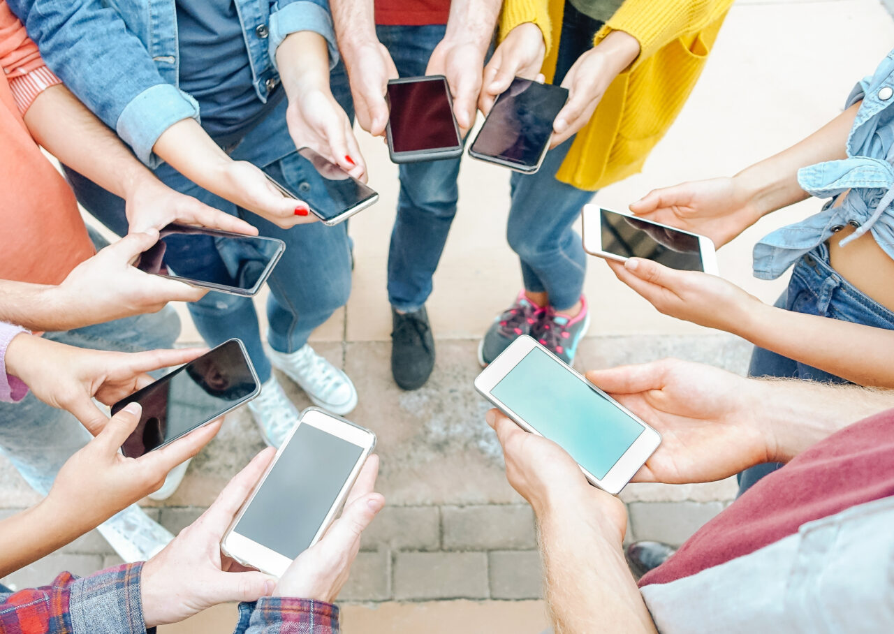 Group of friends using their smart mobile phones - Millennial young people addicted to new technology trends - Concept of people, generation z, tech, social media network and youth lifestyle