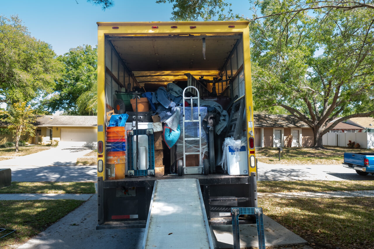 Belongings from a house being loaded into a moving van