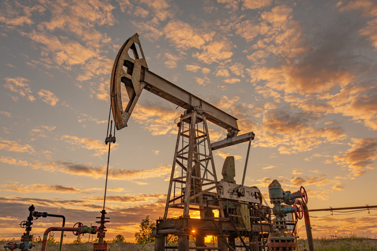 Petroleum concept. Oil pump rig. Oil and gas production. Oilfield site. Pump Jack are running. Drilling derricks for fossil fuels output and crude oil production. Global crisis. War on oil prices.