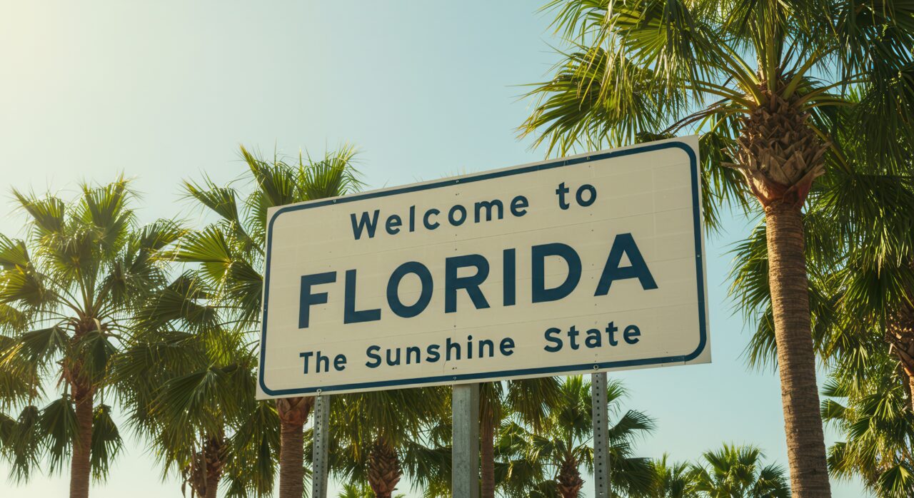 Welcome to Florida Sign with Palm Trees on Sunny Day